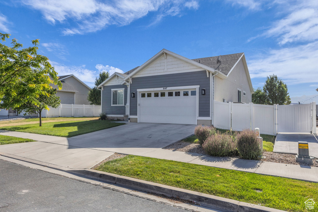 Ranch-style home featuring a garage, a gate, and concrete driveway