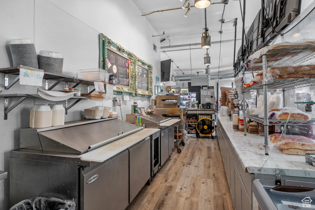 Kitchen with light wood-style floors and light countertops