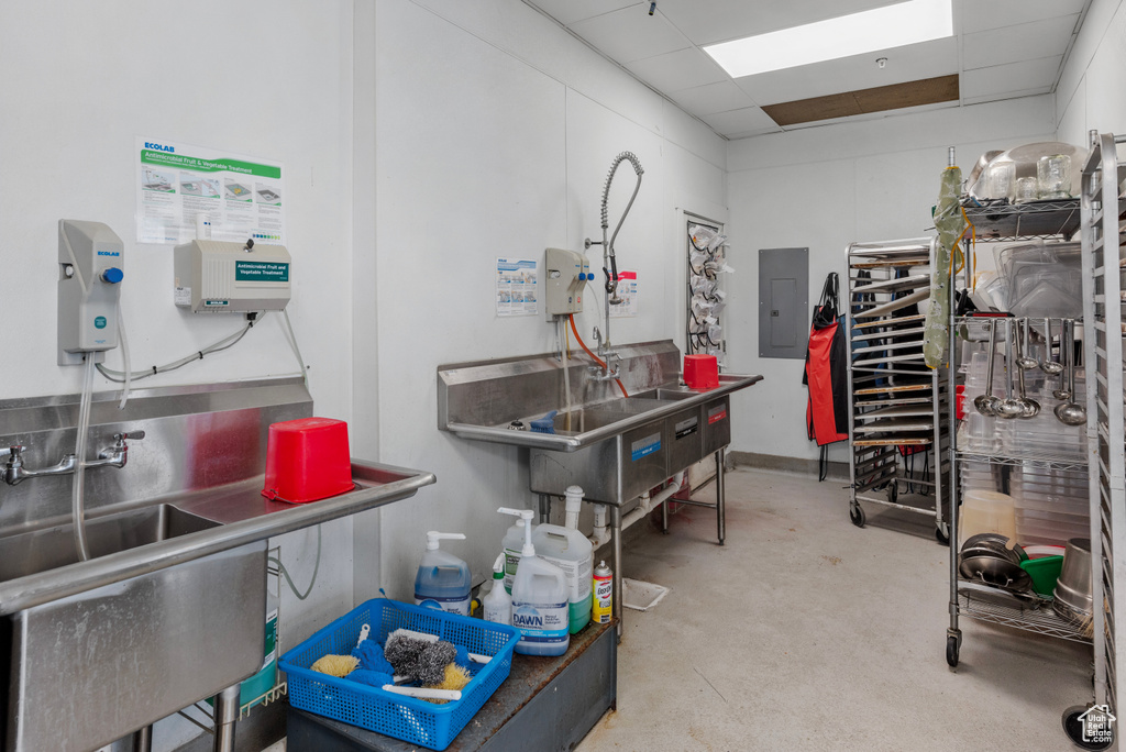 Miscellaneous room featuring electric panel and concrete floors