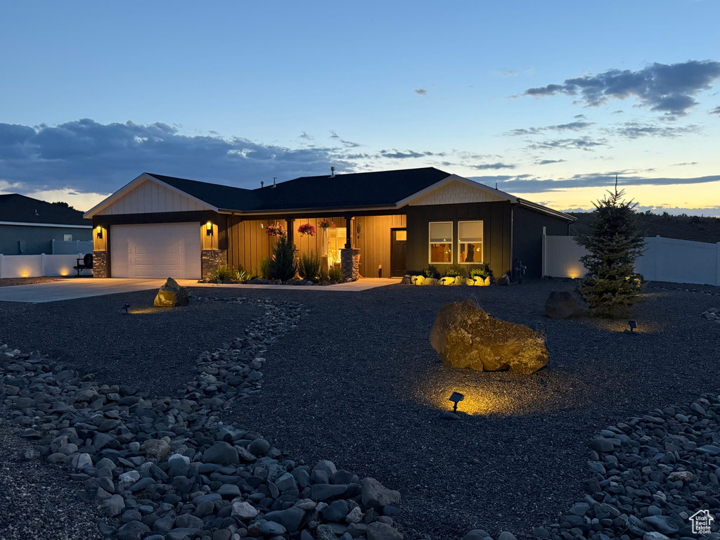 View of front of house with concrete driveway, a garage, and board and batten siding