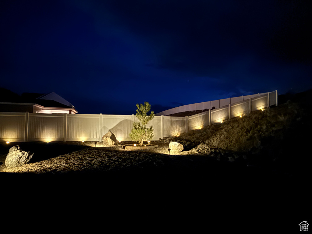 Yard at twilight with a fenced backyard