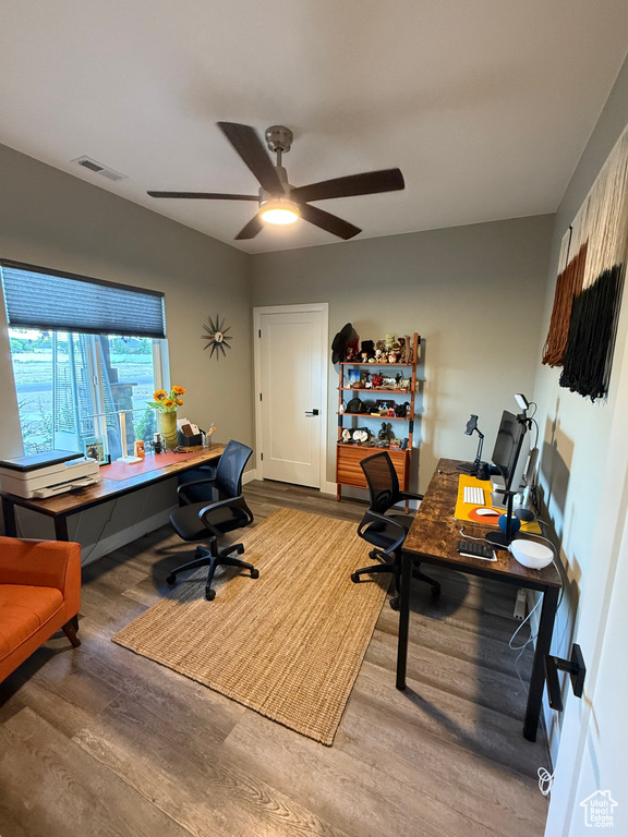 Office with wood finished floors and a ceiling fan