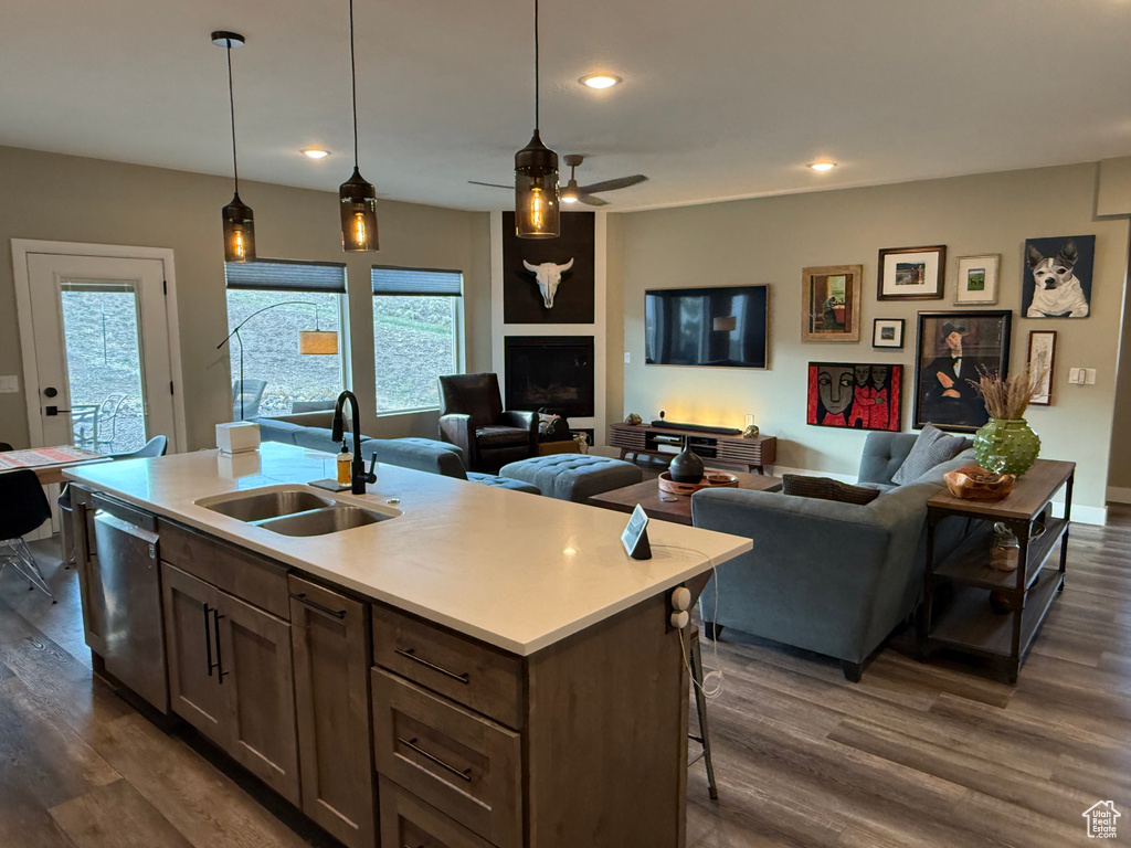 Kitchen featuring dark wood-type flooring, open floor plan, healthy amount of natural light, light countertops, and recessed lighting