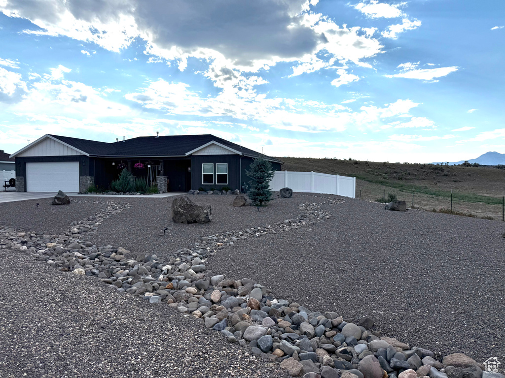 Single story home featuring driveway, a garage, and a mountain view