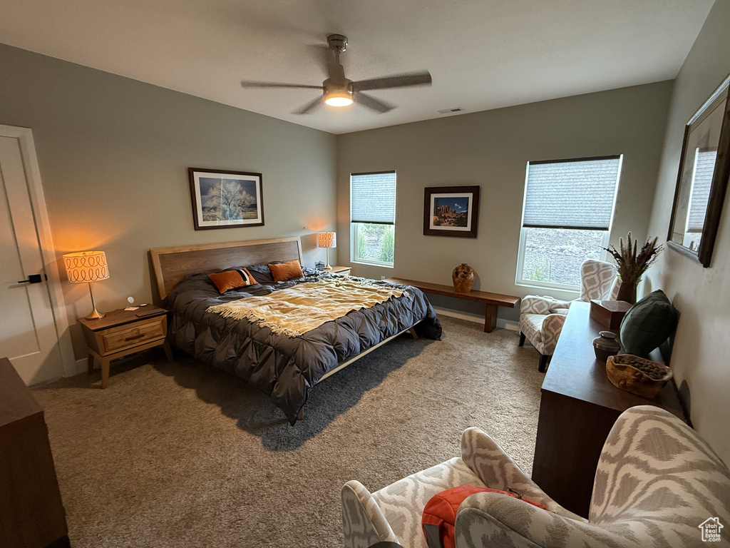 Carpeted bedroom with ceiling fan