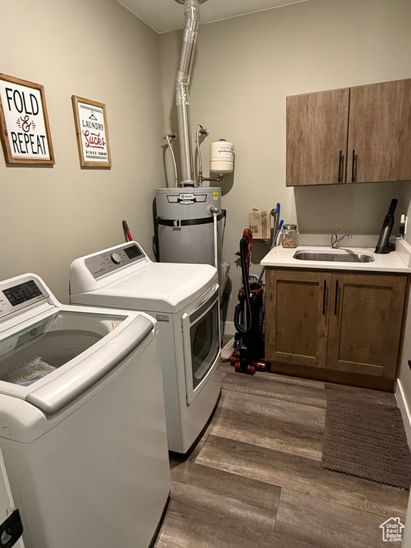 Washroom with cabinet space, separate washer and dryer, dark wood finished floors, and secured water heater