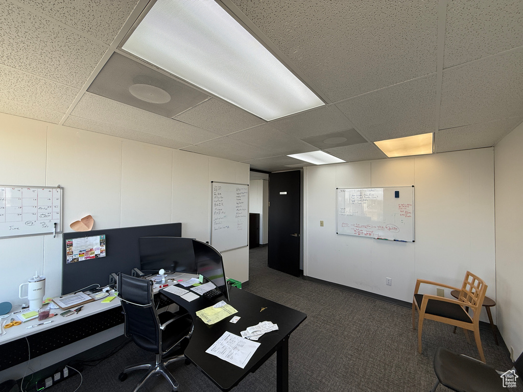 Office featuring a paneled ceiling and dark colored carpet