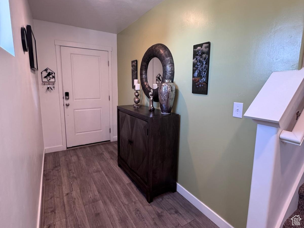 Hall with dark wood-style flooring and stairs