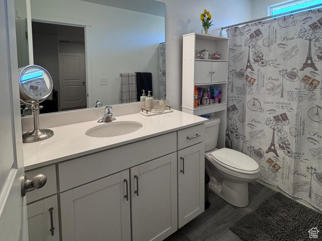 Bathroom with vanity, wood finished floors, a textured ceiling, and a shower with shower curtain