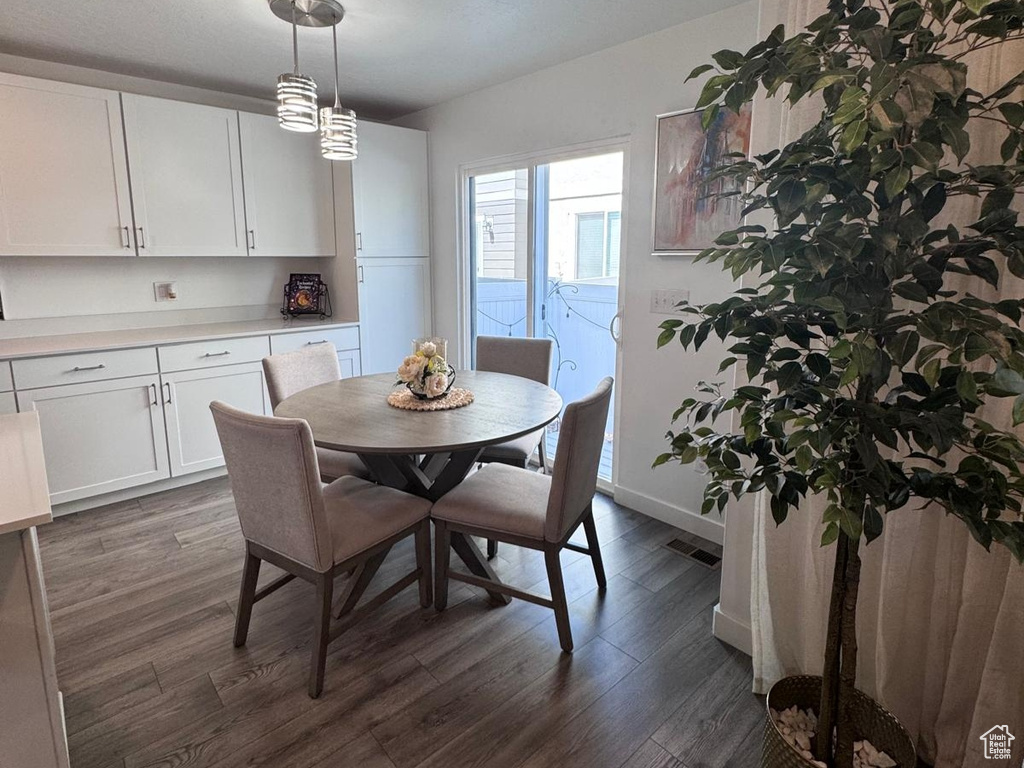 Dining room with dark wood-style floors and a textured ceiling