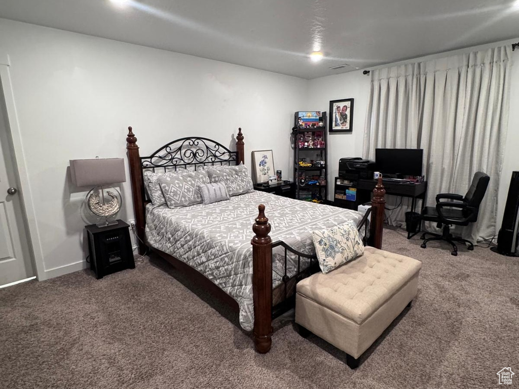 Carpeted bedroom with an office area