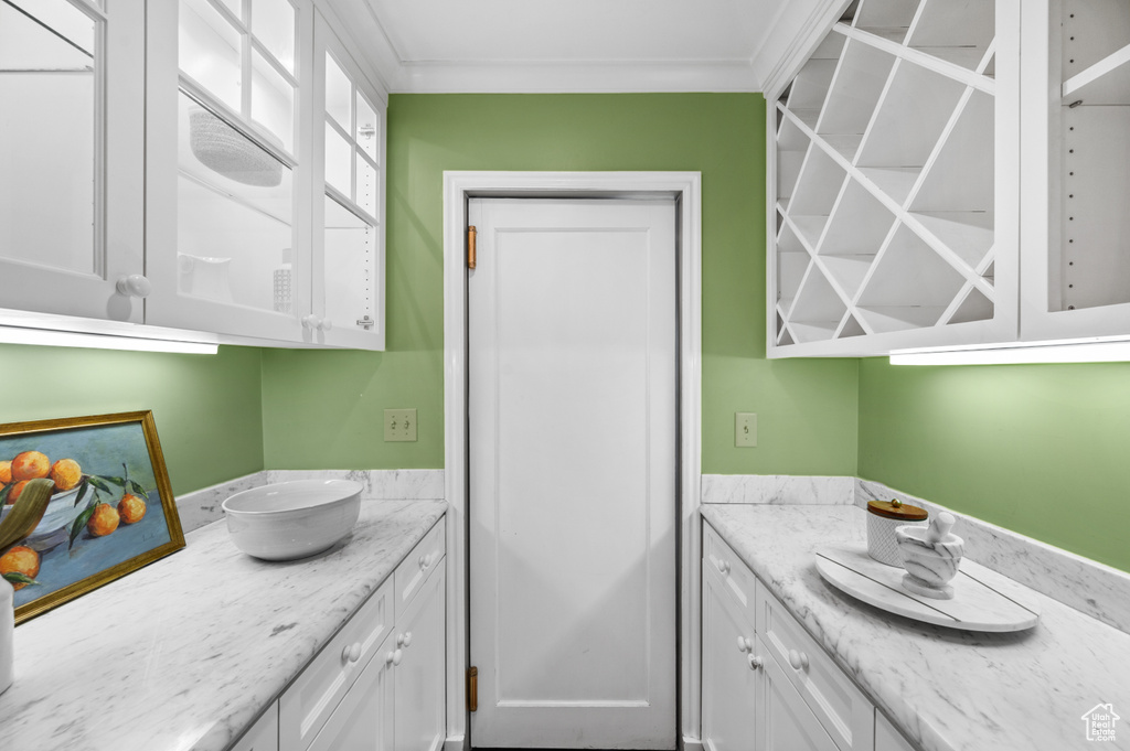 Bathroom with vanity and crown molding