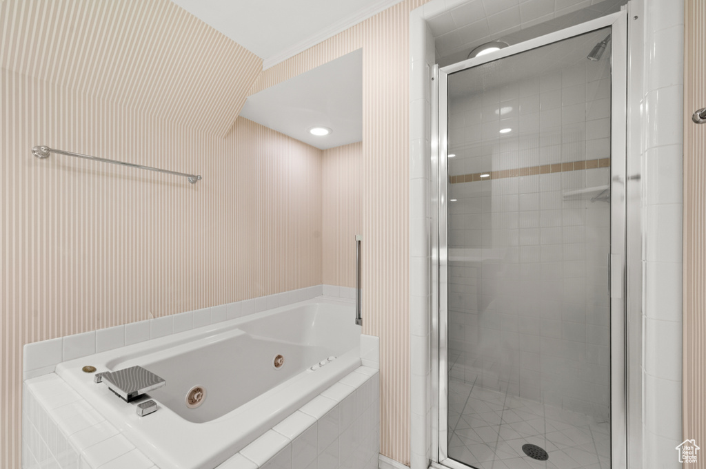 Bathroom featuring a whirlpool tub and a stall shower
