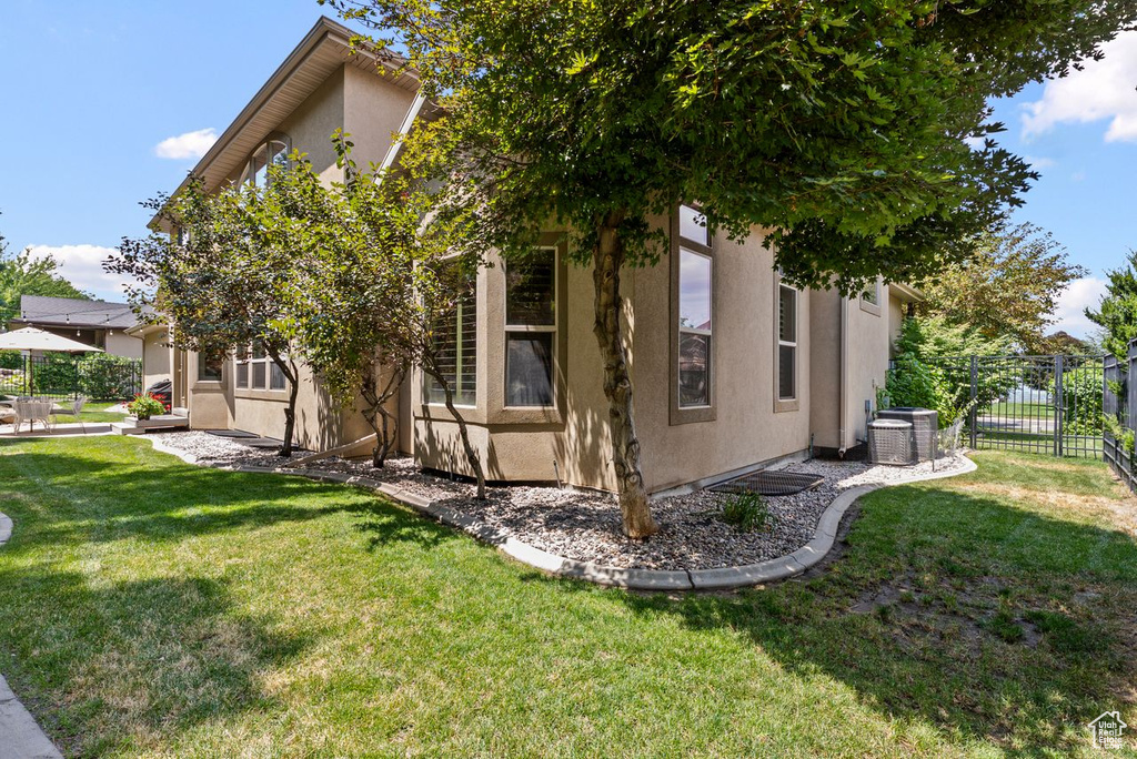 View of property exterior featuring stucco siding and a cooling unit