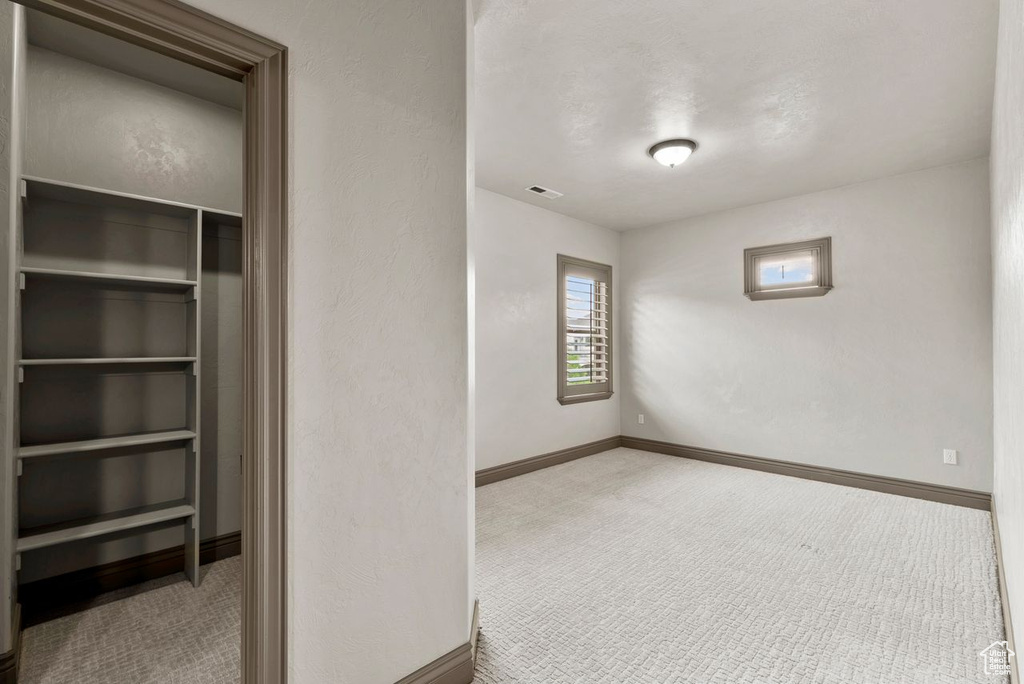 Unfurnished bedroom featuring carpet floors and a closet