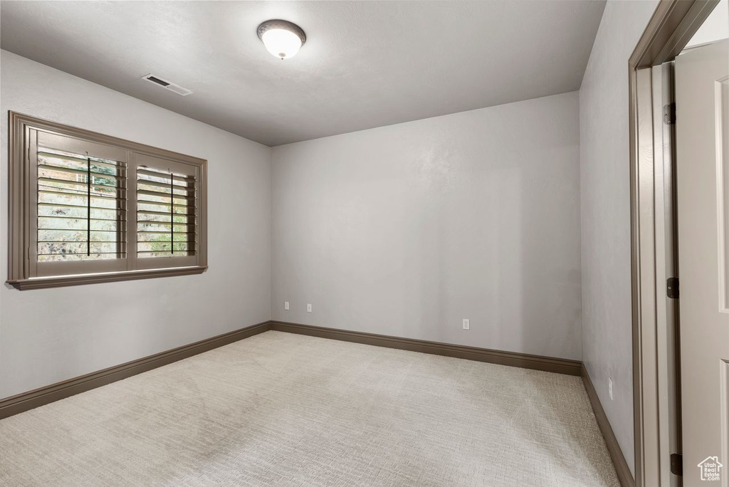 Unfurnished room with light colored carpet