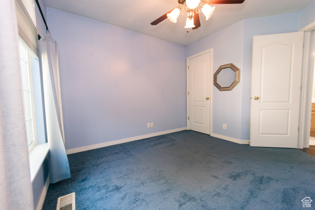 Unfurnished bedroom featuring carpet floors and a ceiling fan