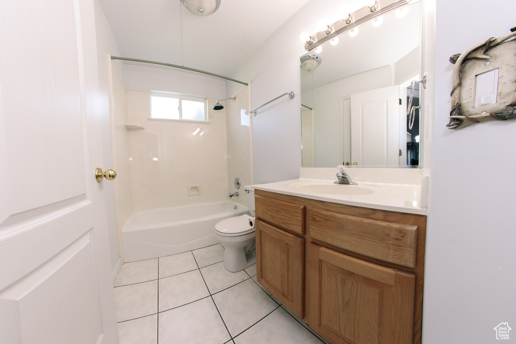 Bathroom featuring vanity, washtub / shower combination, and tile patterned floors