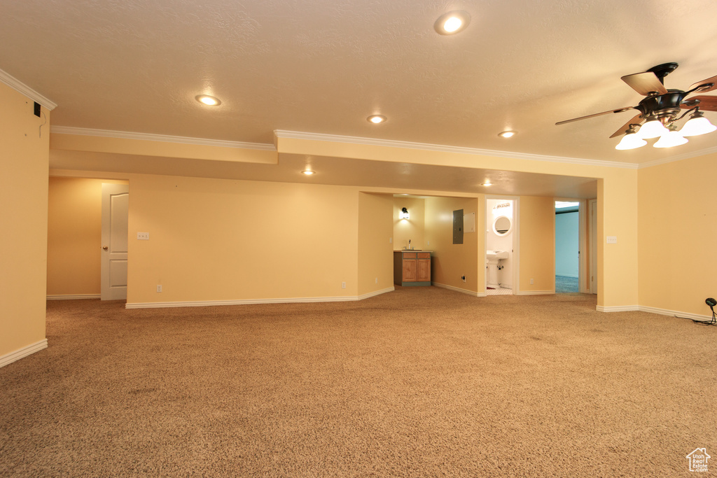 Spare room featuring crown molding, light colored carpet, recessed lighting, and a ceiling fan
