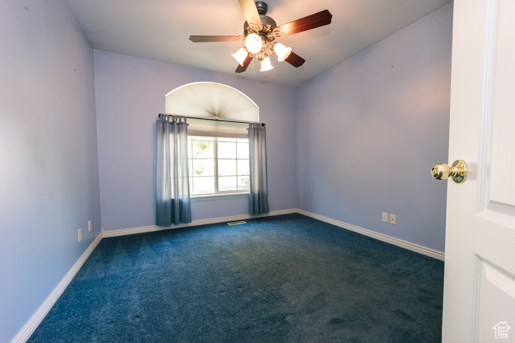 Empty room with carpet flooring and ceiling fan