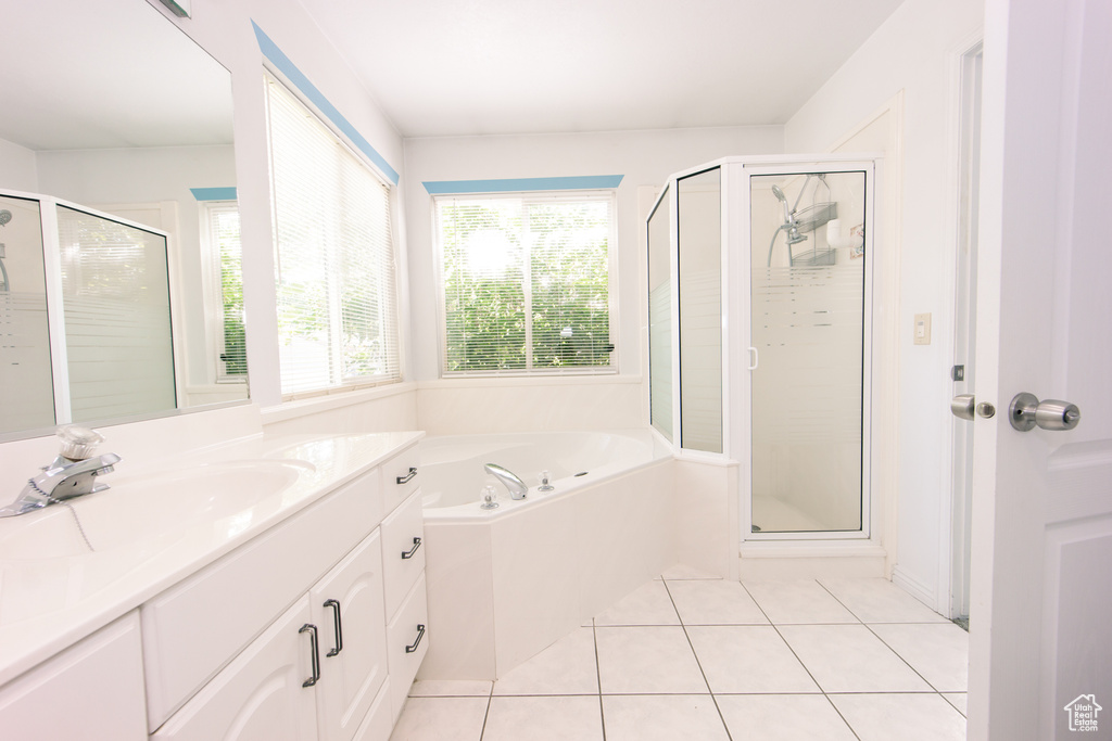 Bathroom featuring a stall shower, vanity, a bath, and tile patterned floors