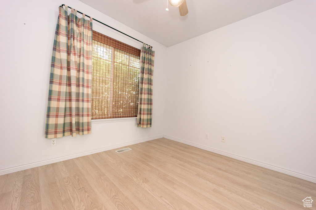 Spare room featuring wood finished floors and ceiling fan
