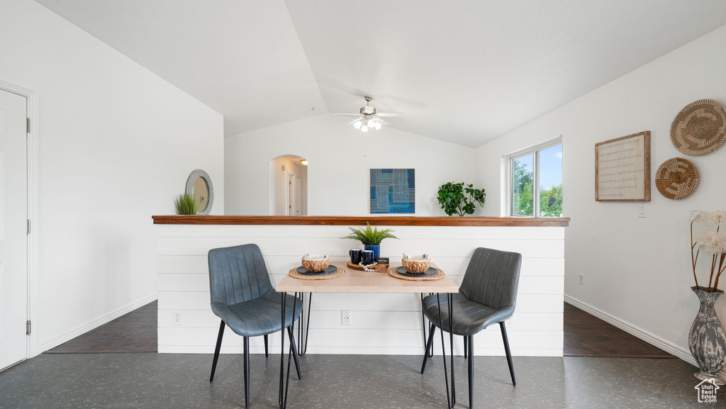 Dining space with lofted ceiling, a ceiling fan, and arched walkways