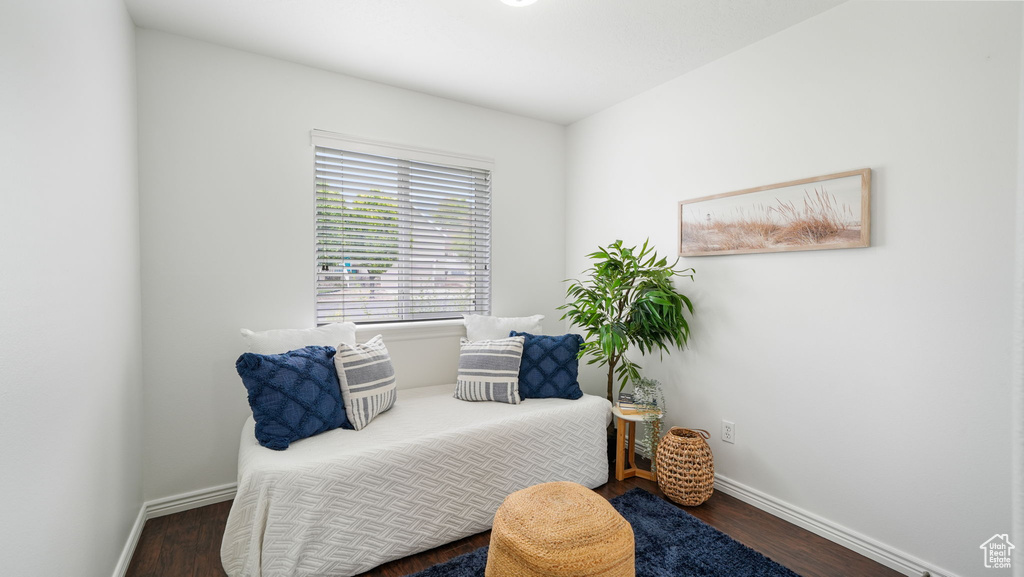 Bedroom with baseboards and wood finished floors