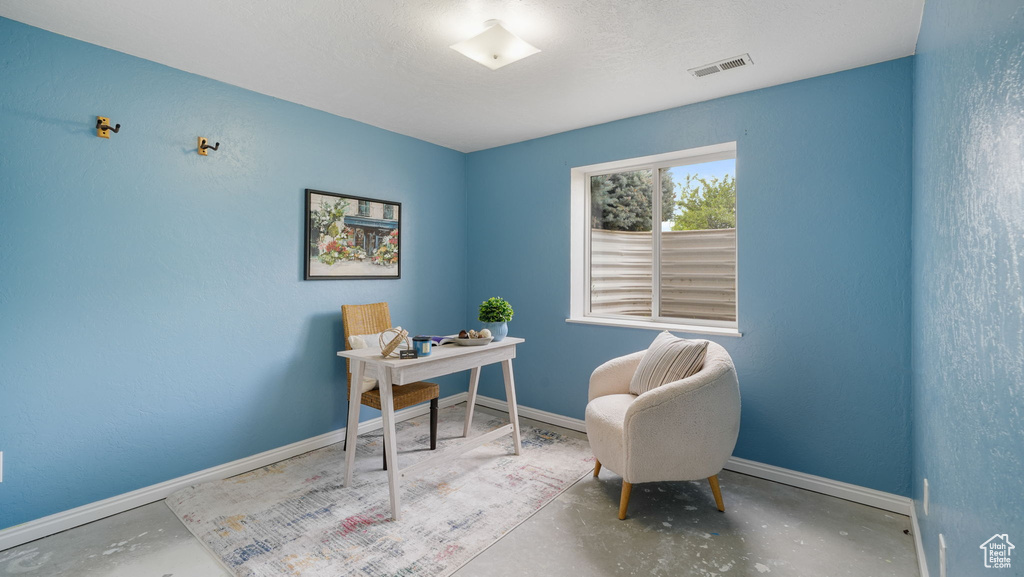 Home office featuring concrete floors