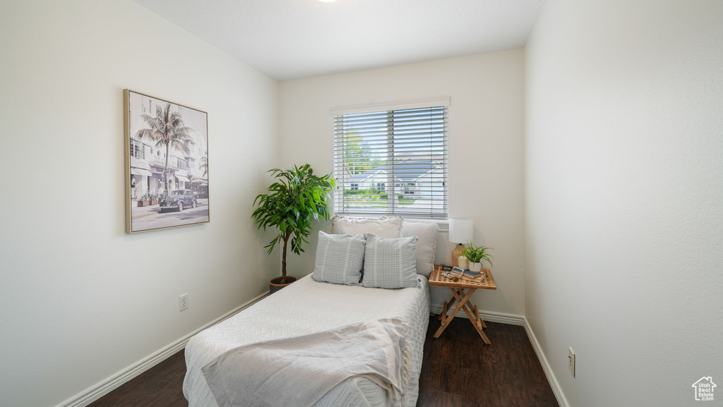 Bedroom with dark wood-style floors
