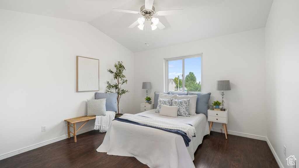 Bedroom featuring lofted ceiling, wood finished floors, and a ceiling fan