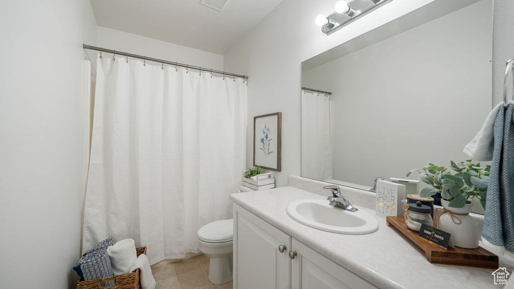 Full bathroom featuring vanity and tile patterned flooring