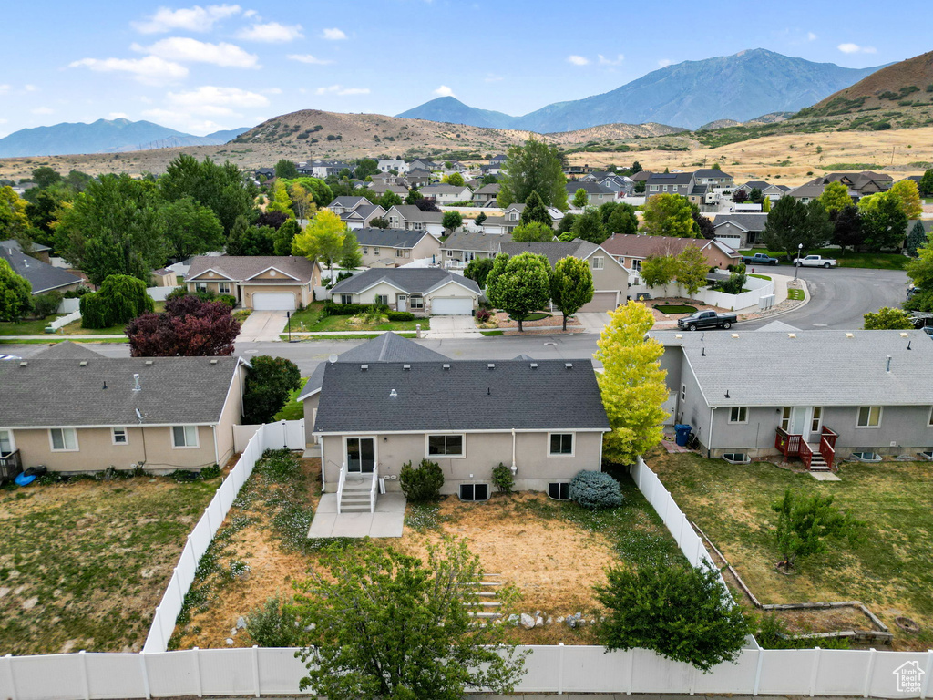Aerial perspective of suburban area featuring a mountain backdrop
