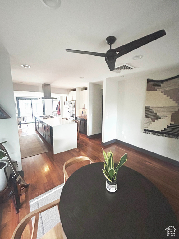 Living room with dark wood finished floors and a ceiling fan