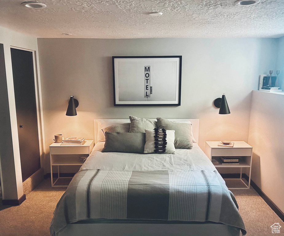 Bedroom with carpet flooring and a textured ceiling