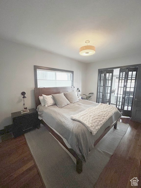 Bedroom with wood finished floors and access to exterior