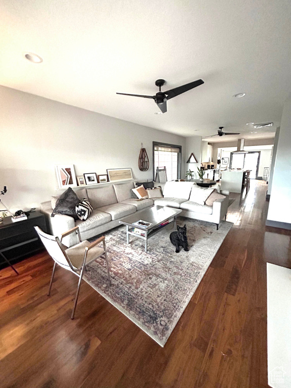 Living area with a ceiling fan, wood finished floors, and recessed lighting