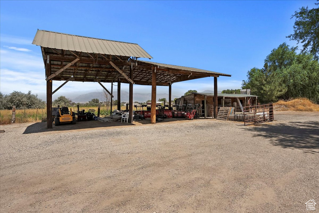 Surrounding community featuring a detached carport and gravel driveway