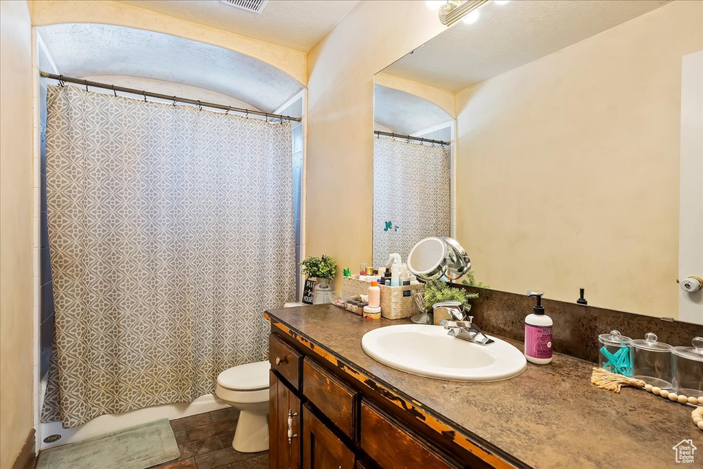 Full bathroom featuring vanity and toilet