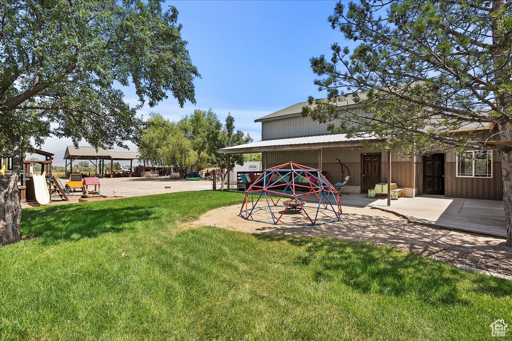 View of green lawn featuring a playground
