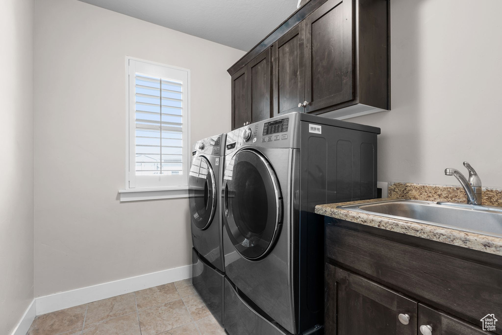 Laundry area with cabinet space and washing machine and dryer