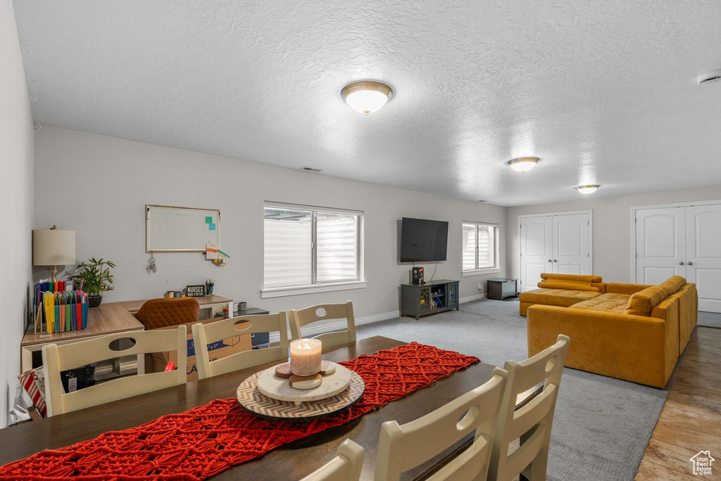 Dining space with a textured ceiling and baseboards
