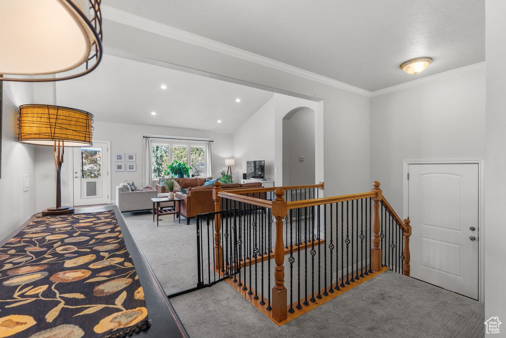 Interior space with carpet, ornamental molding, and recessed lighting