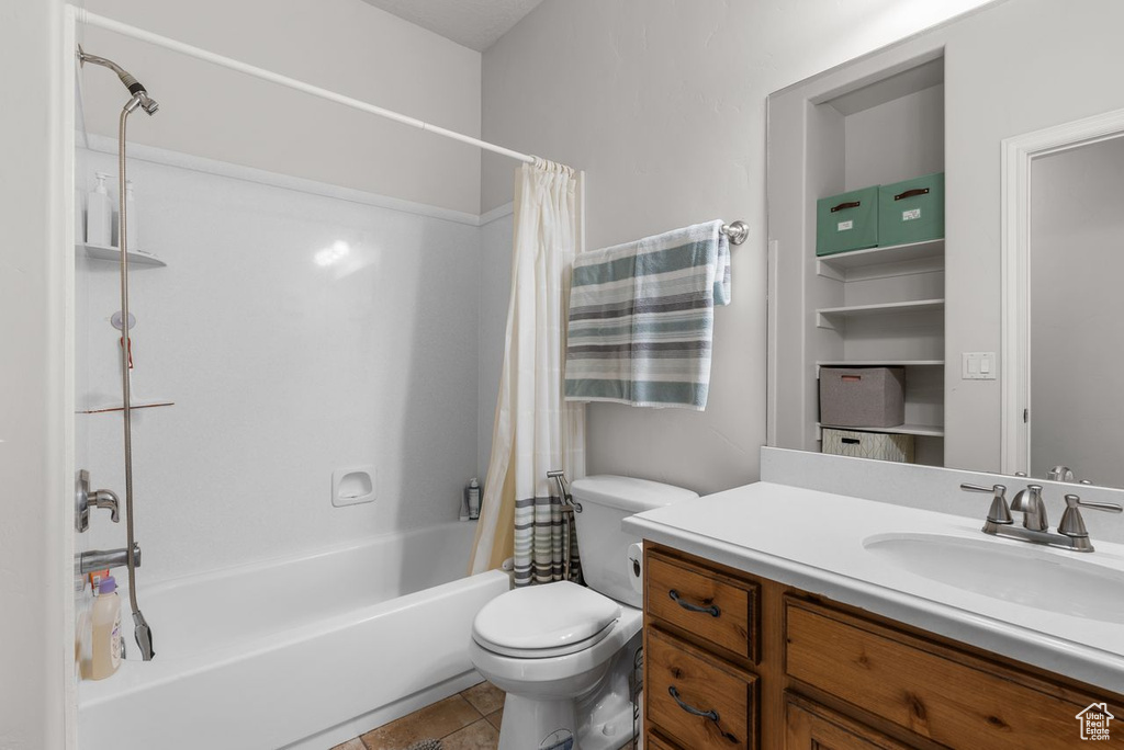 Bathroom featuring vanity, shower / bath combination with curtain, and tile patterned floors