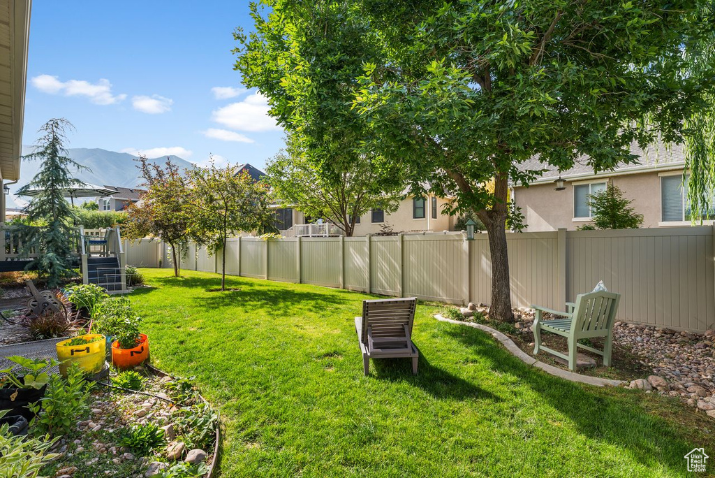 Fenced backyard featuring a mountain view