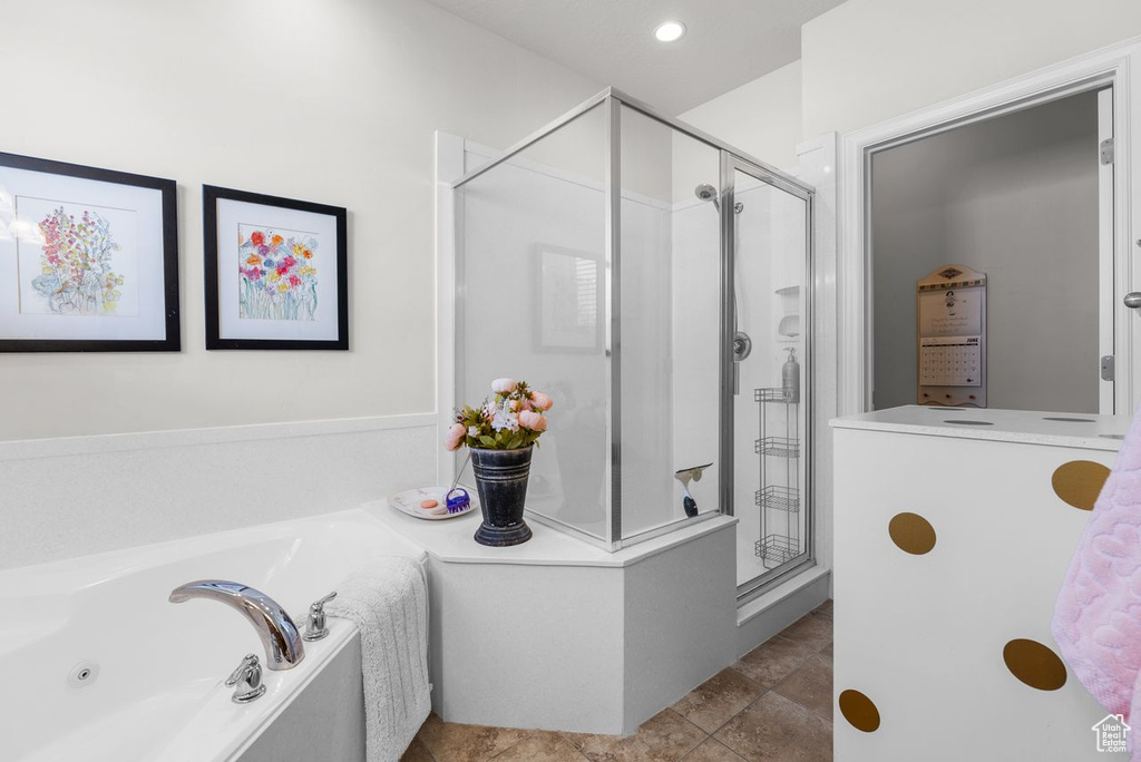 Full bath featuring a shower stall and a garden tub