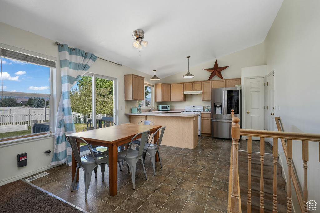 Dining area with high vaulted ceiling