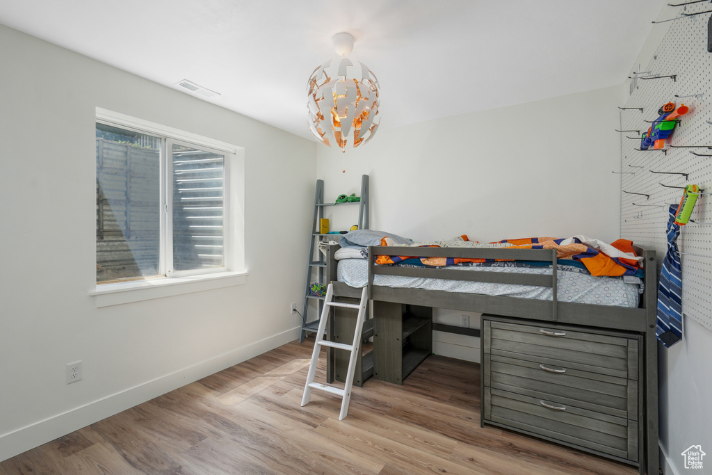 Bedroom featuring wood finished floors and baseboards