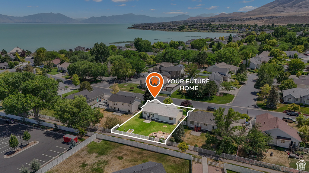 Aerial perspective of suburban area with a water and mountain view and property parcel outlined