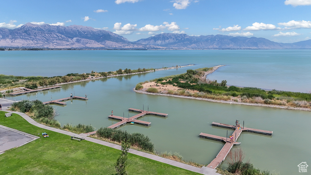 Water view featuring a mountain backdrop and a floating dock